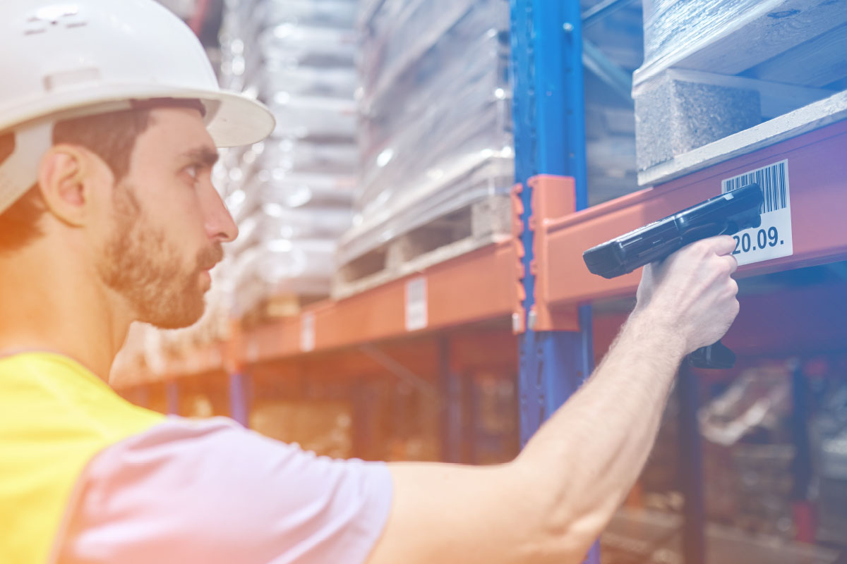 Warehouse manager scanning warehouse rack label